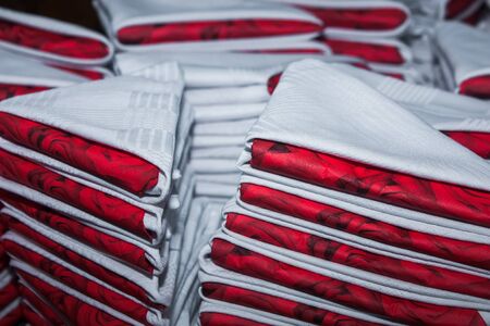 About 200 white and red serviettes with roses are done.の写真素材