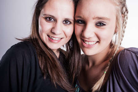 Two friends give a smile for the camera.の写真素材