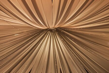 Drapes being lifted up to the roof, to create a bigger space.の写真素材