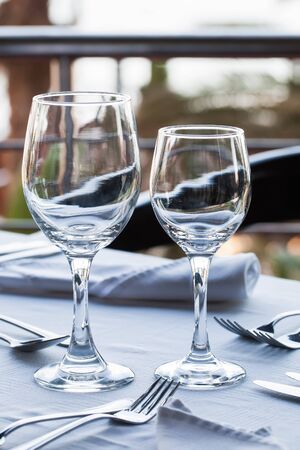 Two wine glasses on a set table.の写真素材