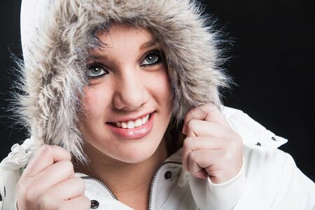 Close-up of ayoung girl dressed in white furry jacket.の写真素材