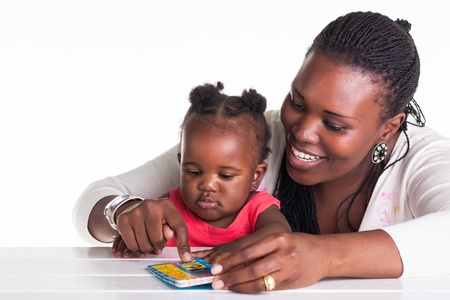 The mother is teaching her daughter some alphabet letters.の写真素材