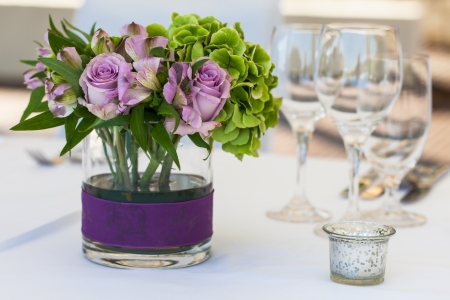 A purple rose center piece on the table.の写真素材