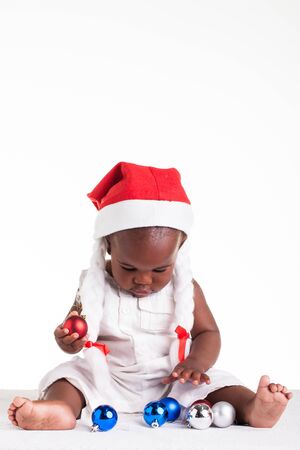 A tiny African baby girl are ready for her first Christmas to arrive.の写真素材