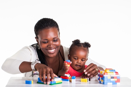A little baby is playing with building block with her mother.の写真素材