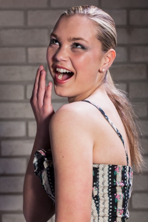 A young lady enjoying her fake smile.の写真素材