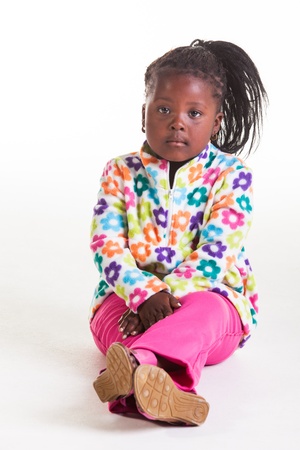 A young African girl in flowers sweater and pink jeans の写真素材