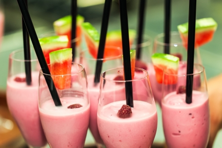 Champagne glasses filled with champagne and strawberry smoothie.の写真素材