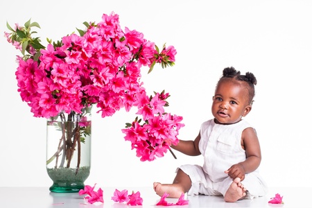 African baby surrounded by flowersの写真素材