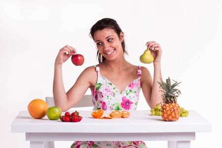 A yong model with a apple and pear in her hands の写真素材