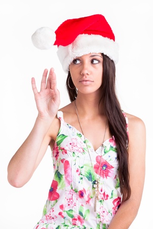 A young girl playing with the furry ball on her Christmas cap の写真素材