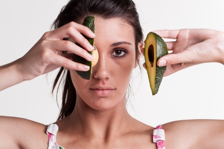 Close-up of a model with a avocado split in two の写真素材