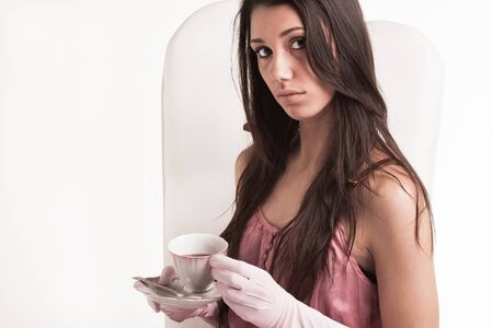 Vintage dressed young lady with cranberry tea の写真素材
