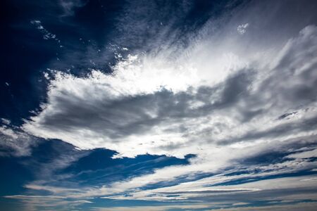 Dark blue skies with grey, white and blue light の写真素材