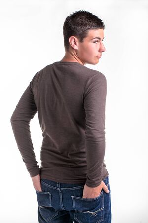 A young teenage boy being photographed in a studio の写真素材