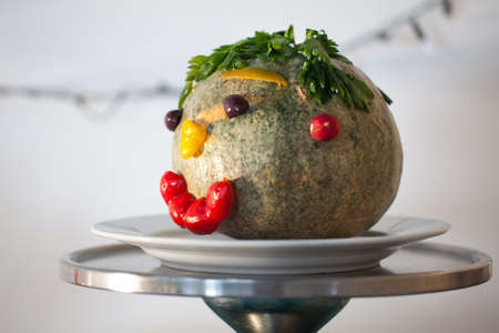 A big pumpkin head with leaves as hair and a smiling face.の写真素材