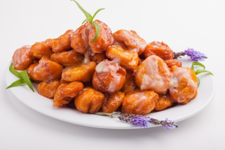 A big plate of freshly made saucy and golden pumpkin fritters.の写真素材