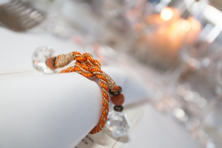 Serviette with candles and orange rope with diamonds.の写真素材