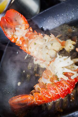 Crayfish being prepared in a a frying pan with oil.の写真素材