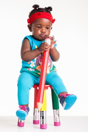 A little African baby with a huge pencil in the hands.の写真素材