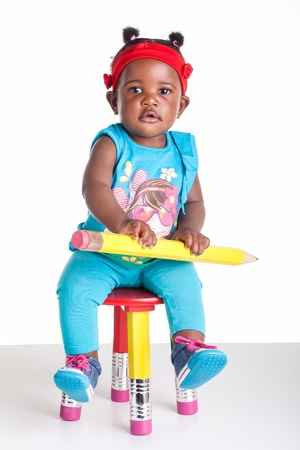 A little African baby with a huge pencil in the hands.の写真素材