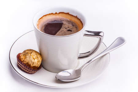 A fancy cup filled with black coffee and being photographed in the studio.の写真素材