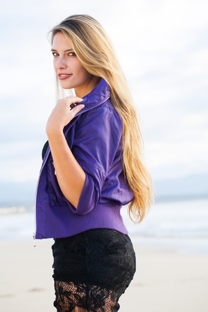 The model dressed in a black dress and a purple jersey.の写真素材
