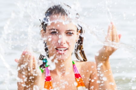 A woman playing in the ocean.の写真素材