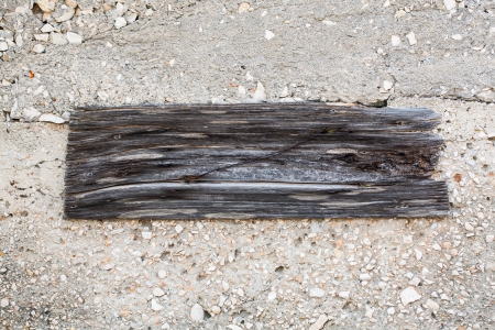 The textures of the cutted plank and the rock wall are hard and grungy.の写真素材