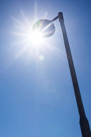 The streetlight with sun streaks passing through.の写真素材