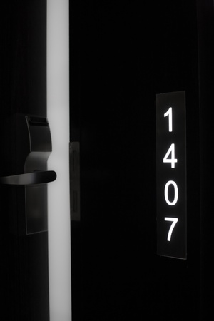 The room number of an open hotel room door.の写真素材