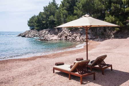 Sun chairs situated on the beach on the islands of Croatia.の写真素材