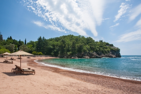 Sun chairs situated on the beach on the islands of Croatia.の写真素材