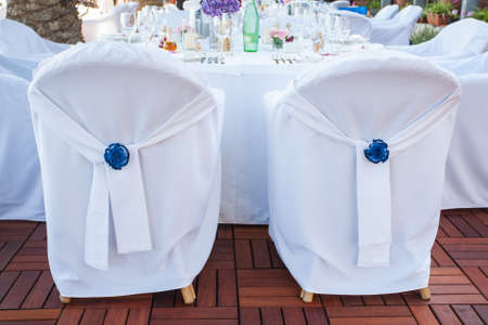 Two chairs that is beautifully decorated for a wedding.の写真素材
