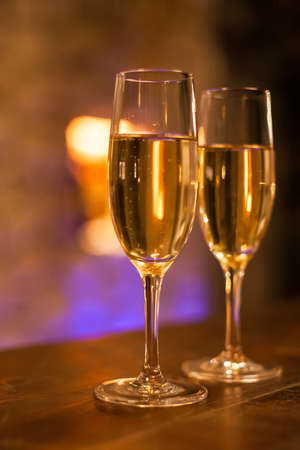 Two glasses filled with white champagne.の写真素材