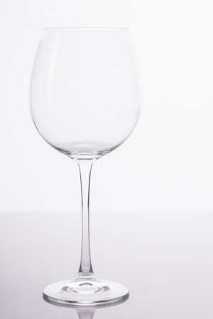 A big empty wine glass being photographed in the studio.の写真素材