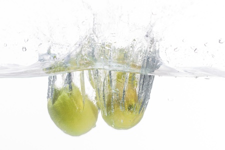 Three lemons in fresh and clean water.の写真素材