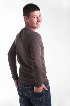 A young teenage boy being photographed in a studio.の写真素材