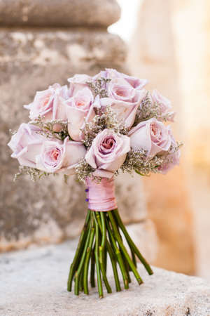 A pink flower bouquet filled with dark pink roses.の写真素材