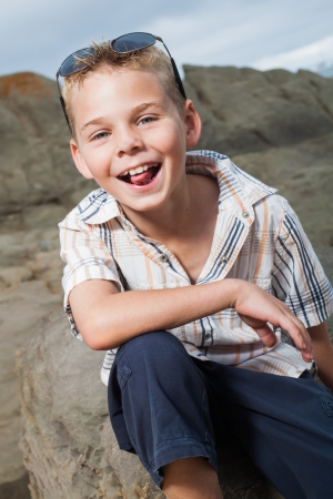 A blond little boy are being photographed on the beach.の写真素材