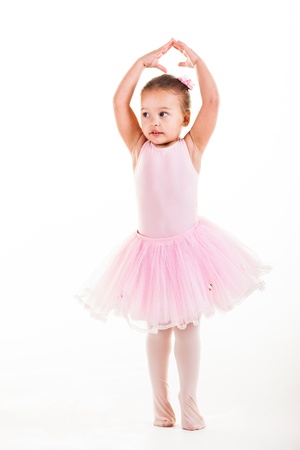 A little pink ballerina in  a playful mood in the studio.の写真素材