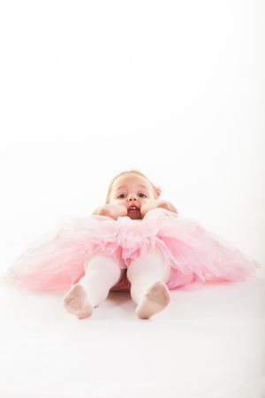 A little pink ballerina in  a playful mood in the studio.の写真素材