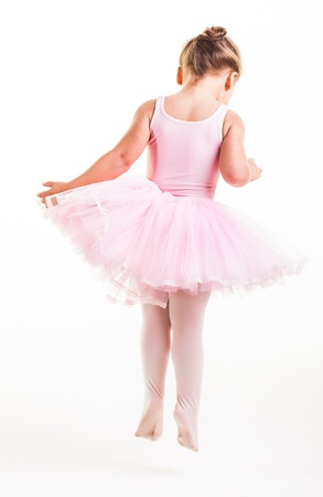 A little pink ballerina in  a playful mood in the studio.の写真素材