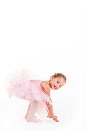 A little pink ballerina in  a playful mood in the studio.の写真素材