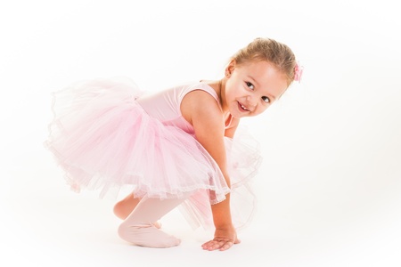 A little pink ballerina in  a playful mood in the studio.の写真素材