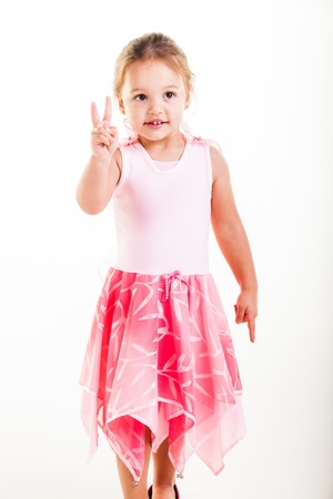 A little girl dressed in a pink fairy outfit in the studio.の写真素材