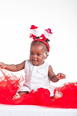 A 8 month old baby dressed to explore Christmas.の写真素材