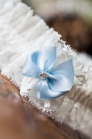 A white linen garter with a blue bow.の写真素材