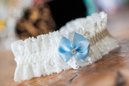 A white linen garter with a blue bow.の写真素材