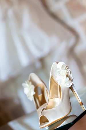 The beautiful shoes of the bride with flowers on the side.の写真素材